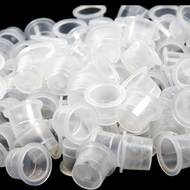A collection of standard conical paint caps made from transparent plastic, suitable for various sizes and professional use in painting or tattooing.