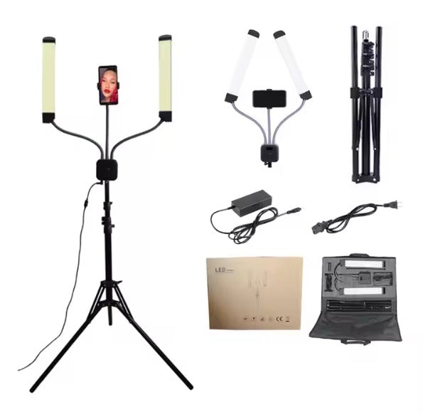 Assembled LED dual-arm lamp with a tripod stand and phone holder, showcasing adjustable lighting for professional use. Includes packaging and components.
