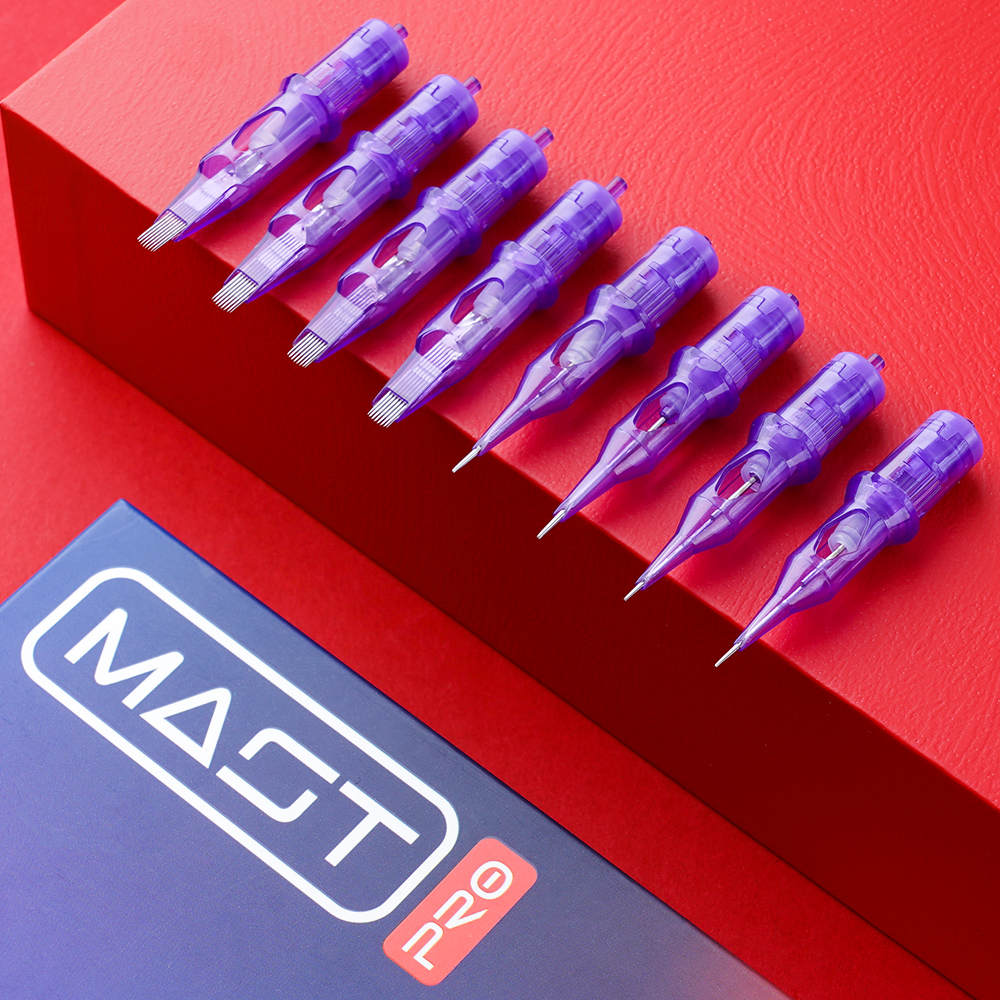 Photograph showing all Mast Pro Tattoo Cartridges arranged next to each other on a red surface. The cartridges are neatly aligned, showcasing the full range of Mast Pro products.