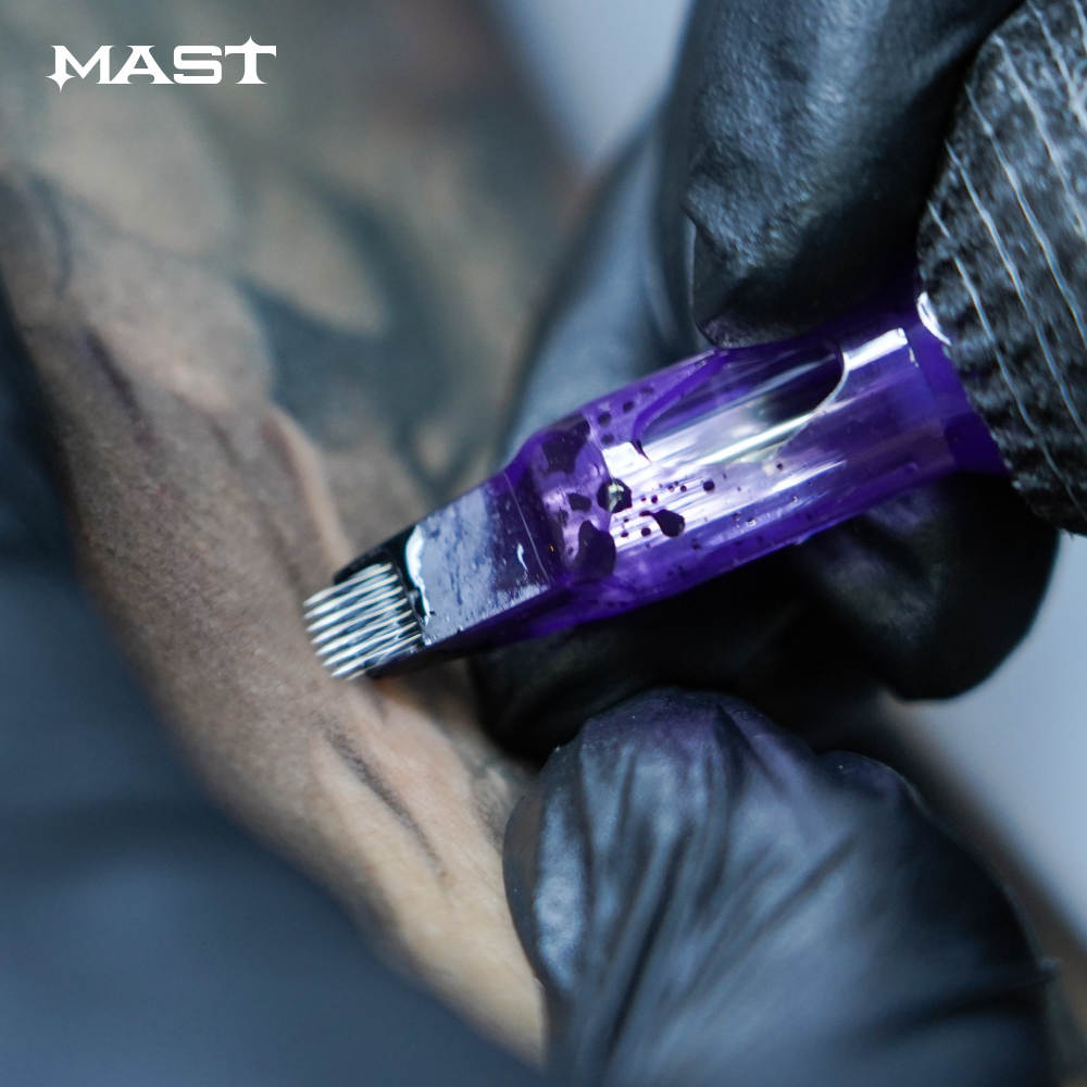 Photograph showing a Mast Pro Tattoo Cartridge in magnum configuration in action. The cartridge is being used in a tattooing process, demonstrating its functionality and performance.