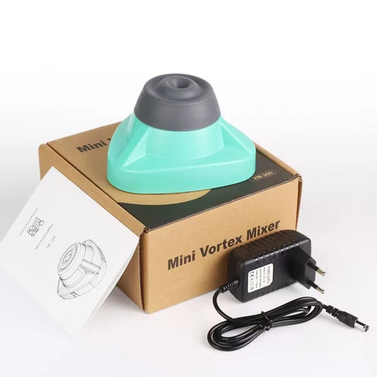 Image of a Mini Vortex Mixer kit featuring a turquoise and gray mixer placed on its packaging box. The kit includes an instruction manual and a power adapter. The design is compact and suitable for laboratory or small-scale mixing applications