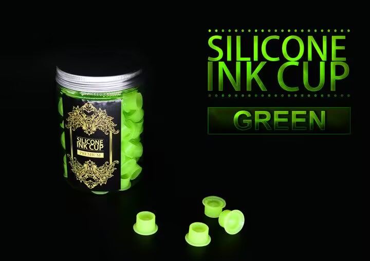 Jar of green silicone ink cups with premium design displayed alongside individual cups, ideal for professional tattooing setups.
