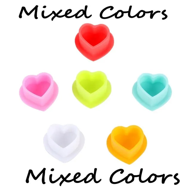 Multi-colored silicone ink cups for tattoo artists, all colors. Pink, white, orange,green, blue and red.