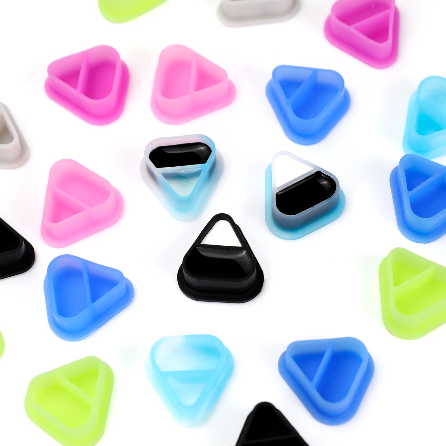 Close-up of SKULLDNA triangle silicone ink cups, featuring dual compartments for pigment mixing.