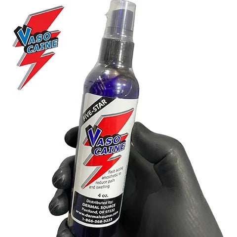 Five-Star Vasocaine anesthetic spray bottle, 120ml, held by a tattoo artist wearing black gloves.