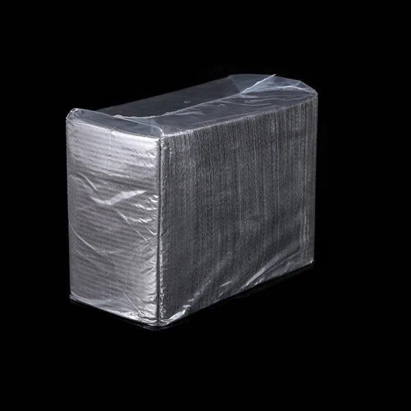 Stacked black disposable mats for professional use