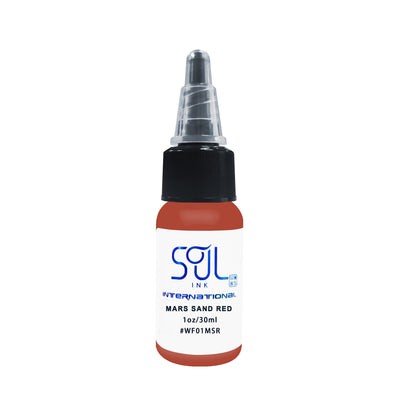 Photograph of a bottle of 'Soul Ink' brand mars sand red ink. The label prominently displays the brand name 'Soul Ink' in stylish blue typography against a white background. The mars sand red 30 ml bottle with a white label featuring the brands name 'Soul Ink'. 