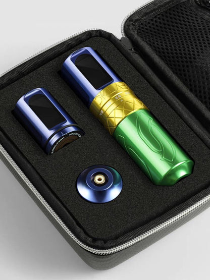 Photograph showcasing the "DKlab" rotary pen-style tattoo machine in blue, gold, and green colors, accompanied by two batteries and an RCA adapter. The device's sleek design and vibrant colors are prominently displayed, offering a glimpse into the versatility and functionality of this rotary machine.