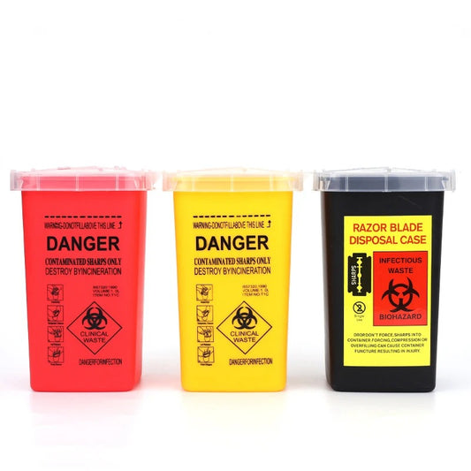 Red, yellow, and black biohazard containers for medical waste disposal, labeled with 'Danger' and 'Biohazard'.