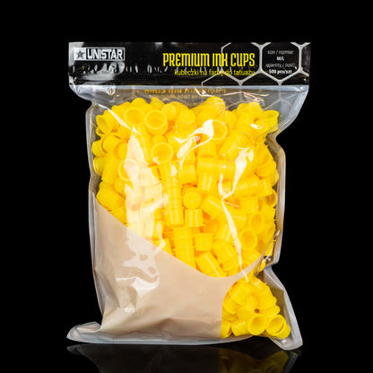 Sealed pack of 500 yellow cone-shaped ink caps for professional tattoo use.