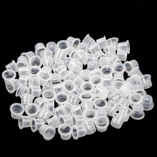 A collection of standard conical paint caps made from transparent plastic, suitable for various sizes and professional use in painting or tattooing