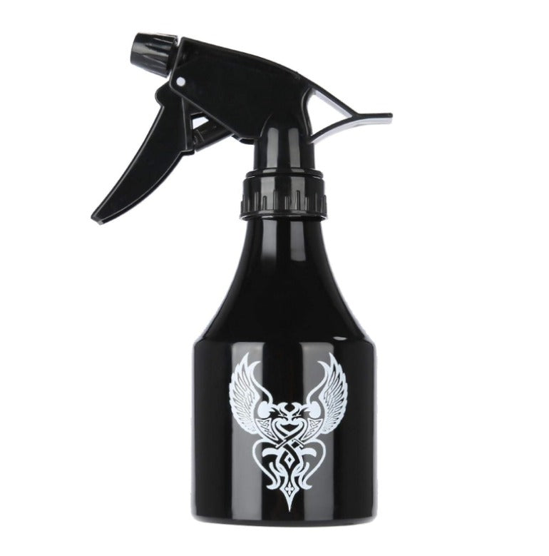 Sleek black spray bottle with ergonomic design and tribal tattoo print, ideal for cleaning tattoo studios.

