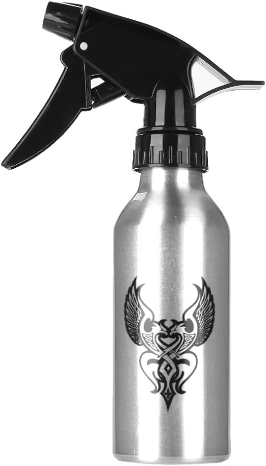 Elegant silver spray bottle featuring tribal tattoo graphics, designed for efficient tattoo studio cleaning.






