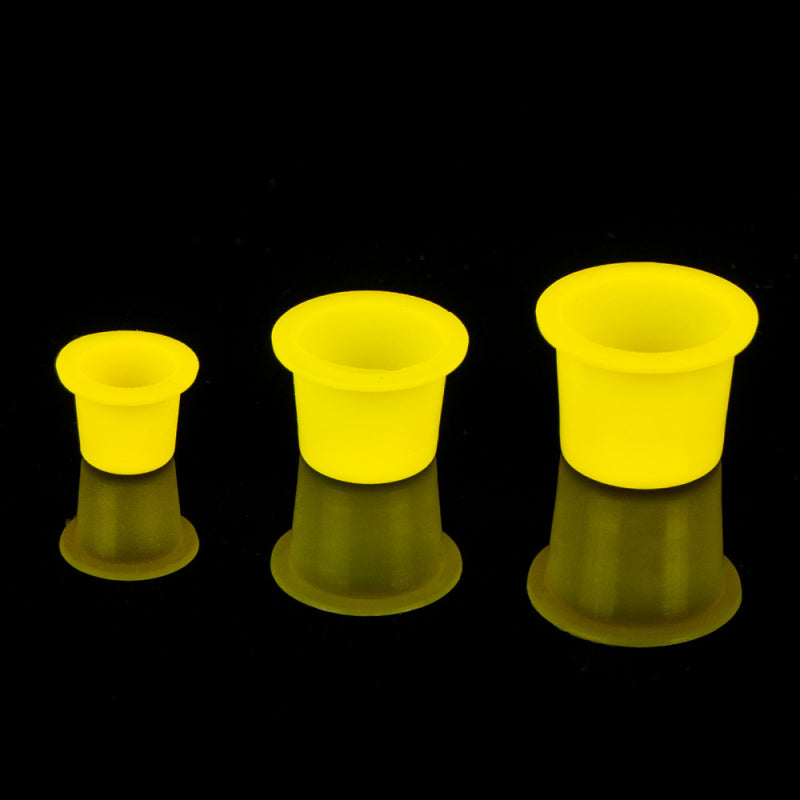 Size comparison of yellow ink caps for tattoo ink – small, medium, and large.